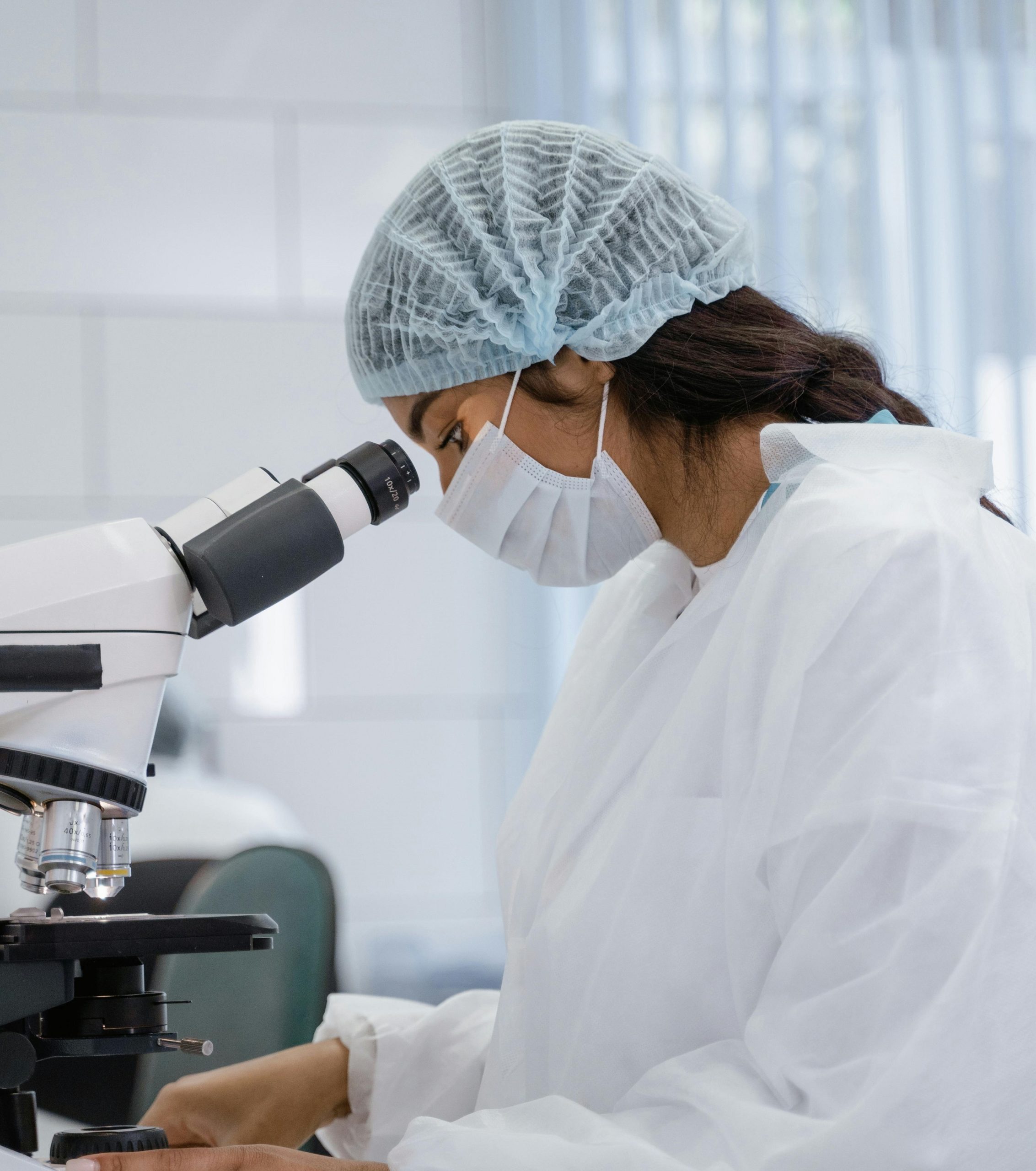 Pathology lab specialist using microscope
